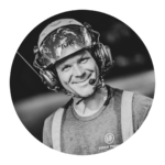 Black and white photo of a smiling worker in safety gear, including helmet, face shield, and "Urban Timber" vest—ready for expert Tree Care or Stump Grinding on your property.